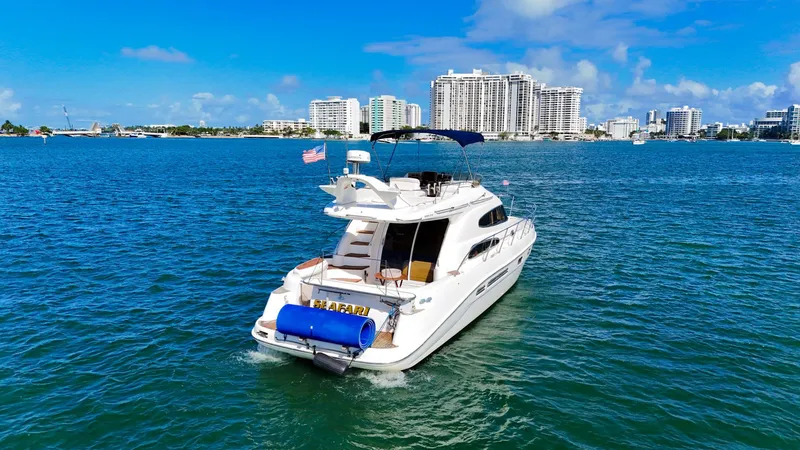 Slide: The Image of 2004 Sealine 47 yacht cruising in sunny waters near city skyline. - 7