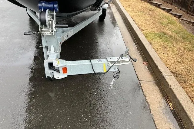 Slide: The Image of Bayliner Element E18 boat trailer hitch on wet pavement, 2023 model. - 8