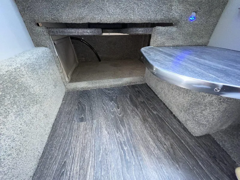Slide: The Image of Interior of 2026 Formula 310 Sun Sport boat with modern flooring and compact storage space. - 18