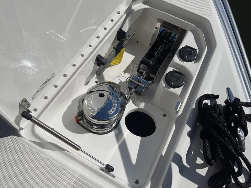 Slide: The Image of 2026 Formula 310 Sun Sport boat anchor compartment with winch and ropes. - 19