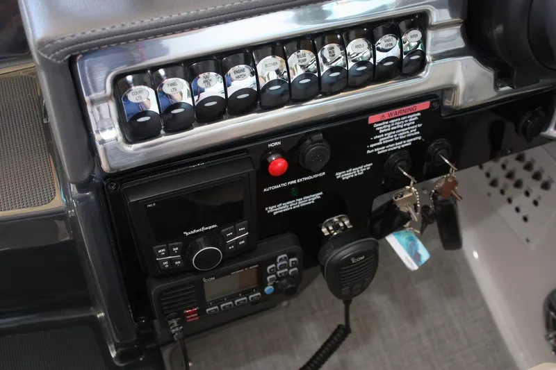 Slide: The Image of Control panel of 2026 Formula 310 Sun Sport boat with switches and communication devices. - 26