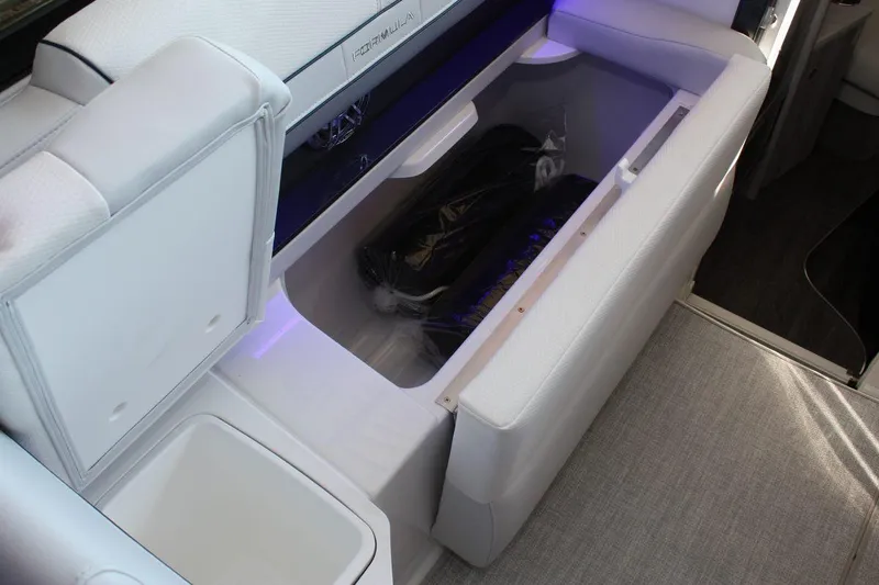 Slide: The Image of 2026 Formula 310 Sun Sport boat interior with open storage compartment and sleek seating. - 35
