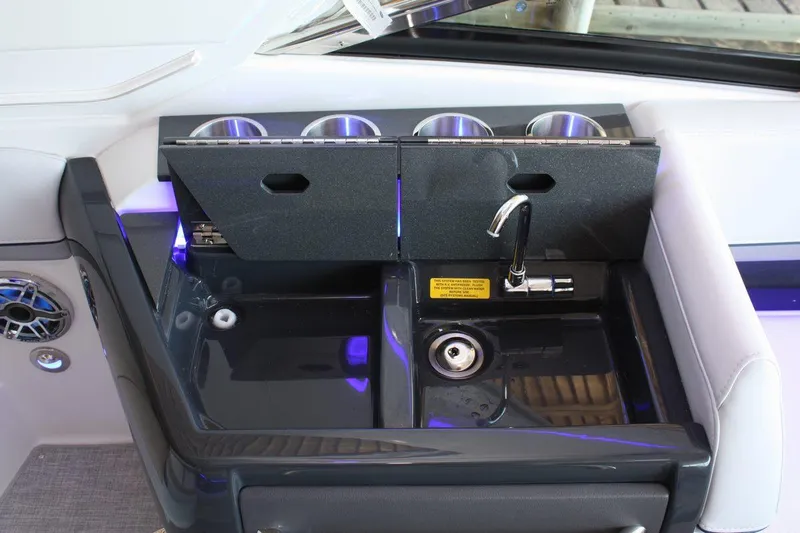 Slide: The Image of 2026 Formula 310 Sun Sport boat sink with faucet and cup holders. - 37
