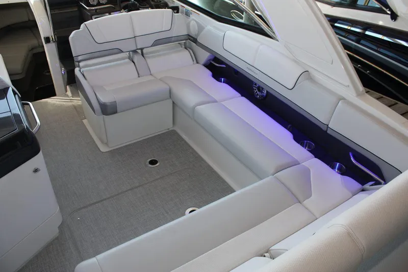 Slide: The Image of 2026 Formula 310 Sun Sport boat interior with plush seating and ambient lighting. - 42