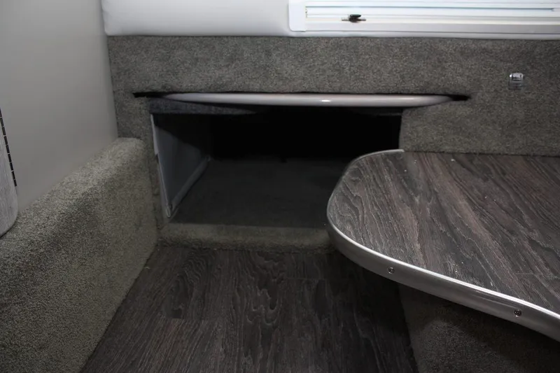 Slide: The Image of Interior of 2026 Formula 310 Sun Sport boat with storage compartment and wooden table. - 49