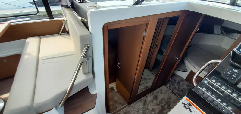 Slide: The Image of Helm station of 2025 Jeanneau NC 1095 Weekender with modern controls and steering wheel. - 14