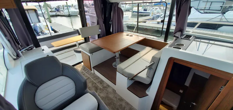Slide: The Image of 2025 Jeanneau NC 1095 Weekender interior with seating and cabin doors. - 15