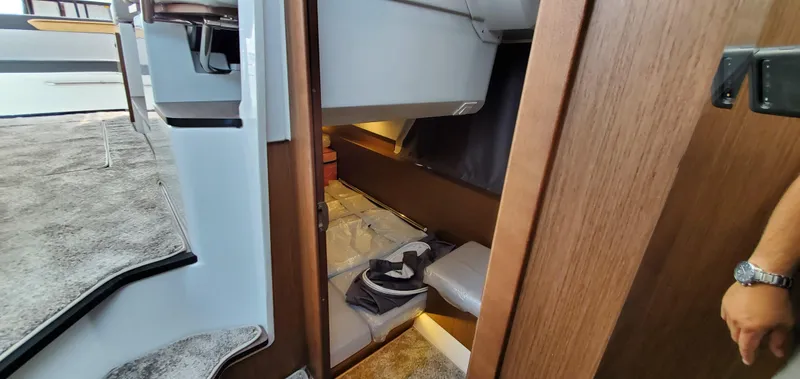 Slide: The Image of 2025 Jeanneau NC 1095 Weekender interior with modern kitchen and marina view. - 17