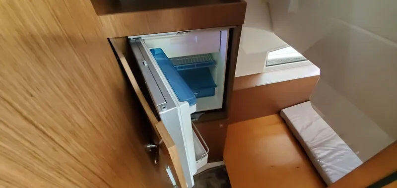 Slide: The Image of 2025 Jeanneau NC 1095 Weekender cabin interior with bed and wooden finish. - 23