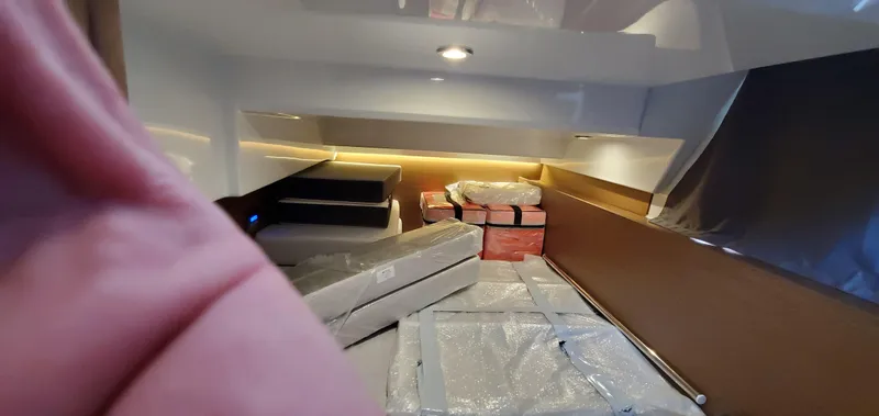 Slide: The Image of Interior stairs of 2025 Jeanneau NC 1095 Weekender with carpeted steps and wooden finish. - 29