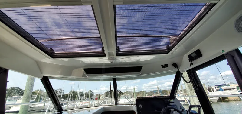 Slide: The Image of Interior view of 2025 Jeanneau NC 1095 Weekender boat with panoramic windows and modern design. - 32