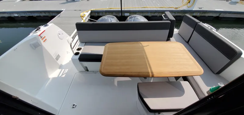 Slide: The Image of Interior view of 2025 Jeanneau NC 1095 Weekender with panoramic sunroof and marina backdrop. - 33