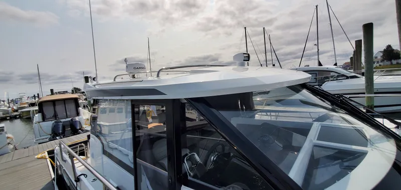 Slide: The Image of 2025 Jeanneau NC 1095 Weekender boat docked, featuring a spacious sunbathing area. - 36