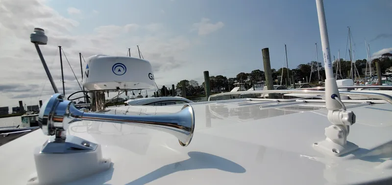 Slide: The Image of 2025 Jeanneau NC 1095 Weekender docked at marina, showcasing sleek design and modern features. - 37