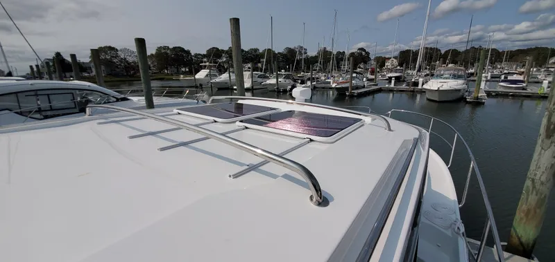 Slide: The Image of 2025 Jeanneau NC 1095 Weekender boat deck with horn and radar, docked at marina. - 38