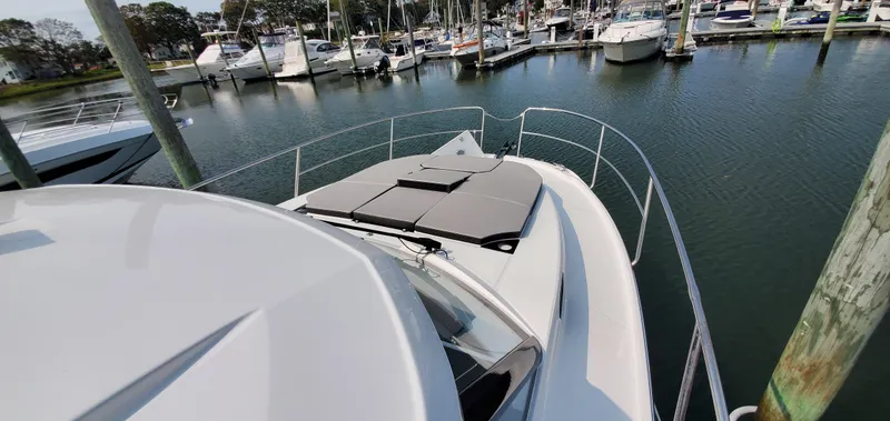 Slide: The Image of 2025 Jeanneau NC 1095 Weekender docked, featuring solar panels on the roof. - 39