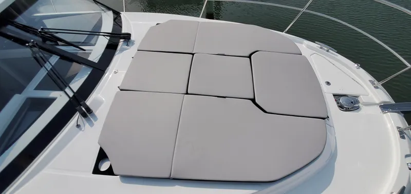 Slide: The Image of 2025 Jeanneau NC 1095 Weekender docked in a marina, featuring a spacious sun deck. - 40