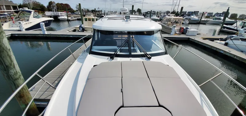 Slide: The Image of 2025 Jeanneau NC 1095 Weekender boat with cushioned sunbathing area on deck. - 42