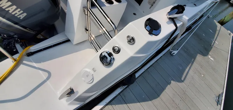 Slide: The Image of 2025 Jeanneau NC 1095 Weekender boat detail, featuring a fuel cap and dockside view. - 45
