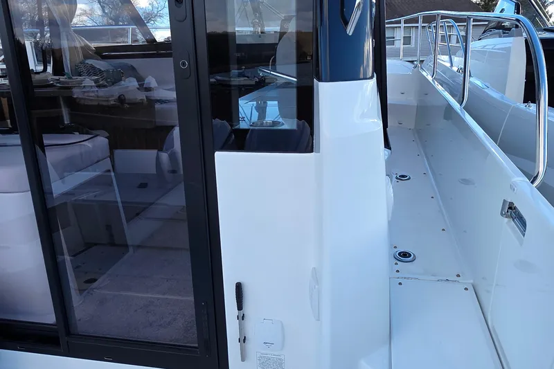 Slide: The Image of 2026 Jeanneau NC 1095 Coupe boat, featuring sleek deck and modern interior design. - 58