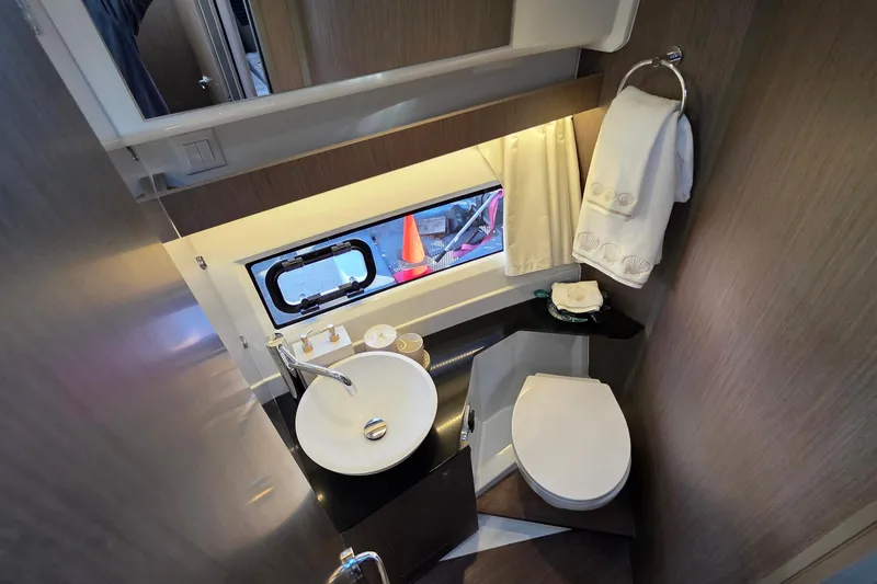 Slide: The Image of Modern bathroom in 2026 Jeanneau NC 1095 Coupe yacht, featuring sink, toilet, and window. - 65
