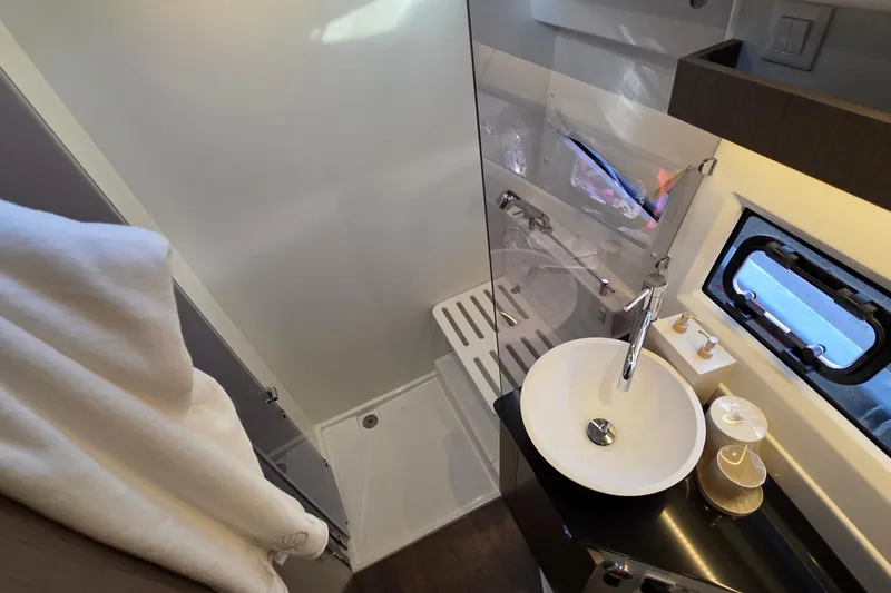 Slide: The Image of Modern bathroom in 2026 Jeanneau NC 1095 Coupe boat with sleek fixtures and window. - 66