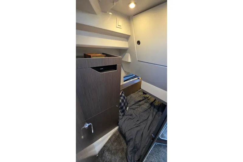 Slide: The Image of 2026 Jeanneau NC 1095 Coupe cabin interior with cozy bed and modern design. - 67