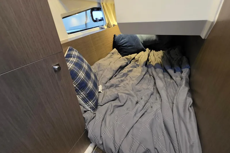 Slide: The Image of Cozy cabin interior of 2026 Jeanneau NC 1095 Coupe with bed and pillows. - 68