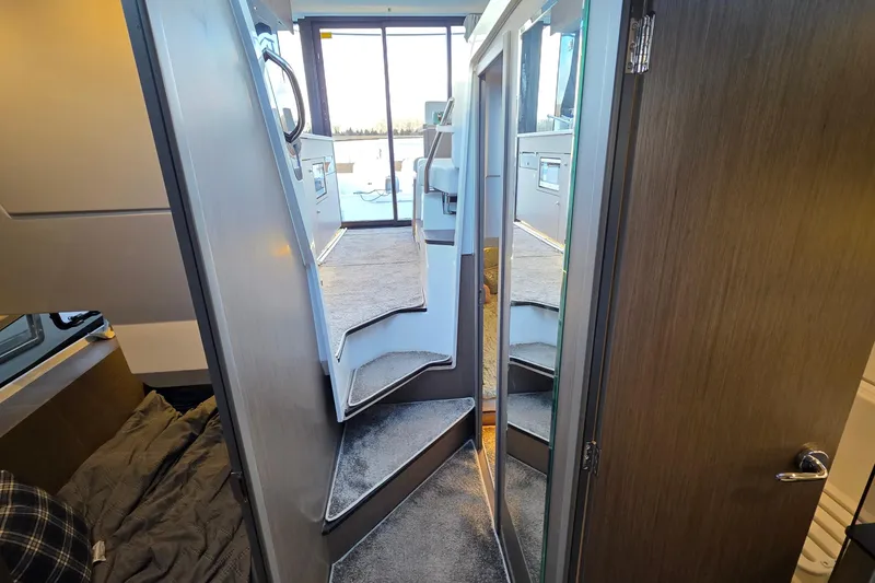 Slide: The Image of Interior view of 2026 Jeanneau NC 1095 Coupe, featuring modern stairs and sleek design. - 69