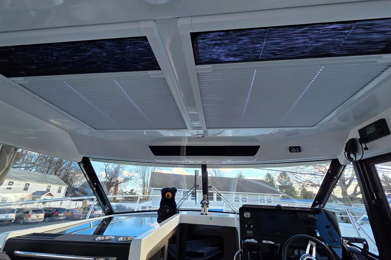 Slide: The Image of Interior view of 2026 Jeanneau NC 1095 Coupe boat cockpit with modern design features. - 71