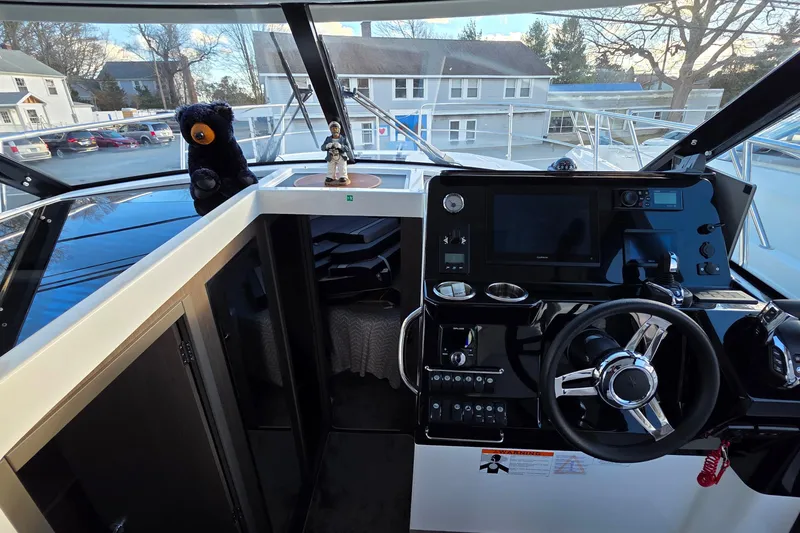Slide: The Image of Interior view of 2026 Jeanneau NC 1095 Coupe boat cockpit with steering wheel and controls. - 72
