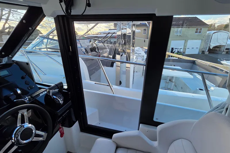 Slide: The Image of Interior view of 2026 Jeanneau NC 1095 Coupe boat, showcasing helm and seating area. - 73