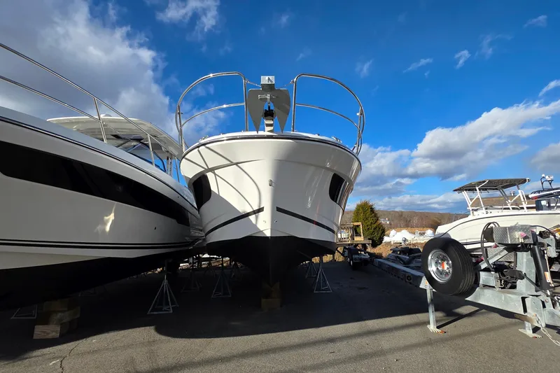 Slide: The Image of 2026 Jeanneau NC 1095 Coupe boat on display under a clear blue sky. - 75