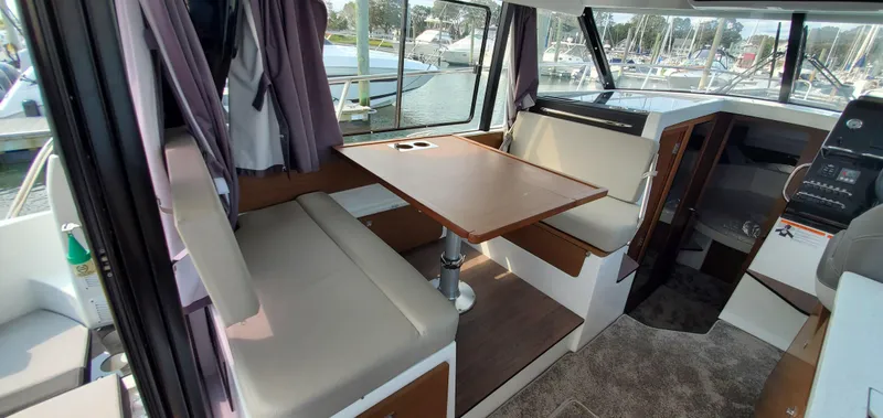 Slide: The Image of Interior of 2025 Jeanneau NC 1095 Weekender with cozy seating and scenic ocean view. - 8