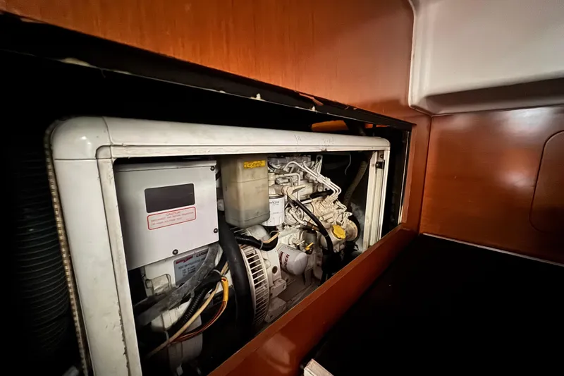 Slide: The Image of Engine compartment of a 2011 Beneteau Oceanis 50 sailboat, showcasing mechanical components. - 39
