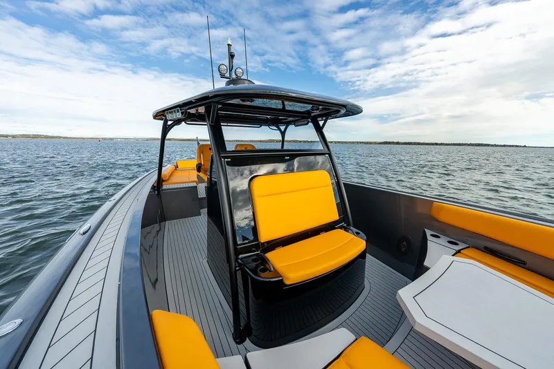Slide: The Image of 2025 Wajer 38s boat with sleek design and vibrant yellow seating on open water. - 13