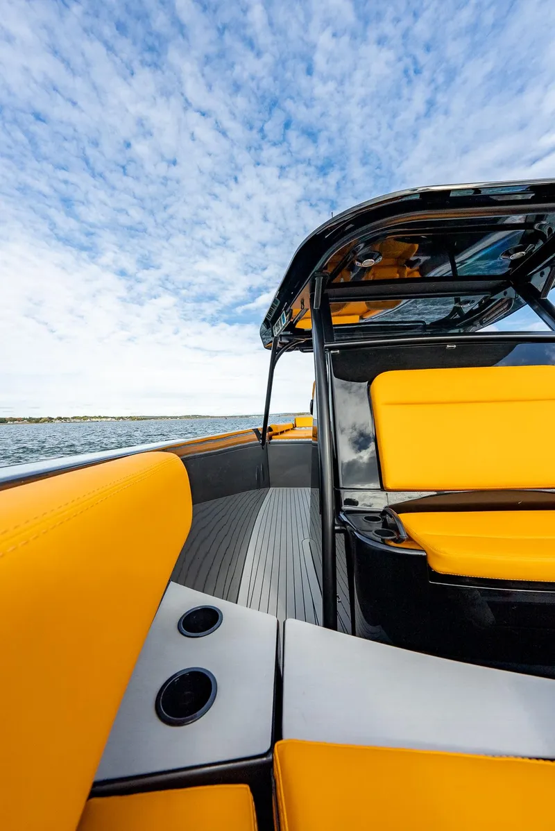 Slide: The Image of 2025 Wajer 38s boat with vibrant yellow seating and sleek design on open water. - 14