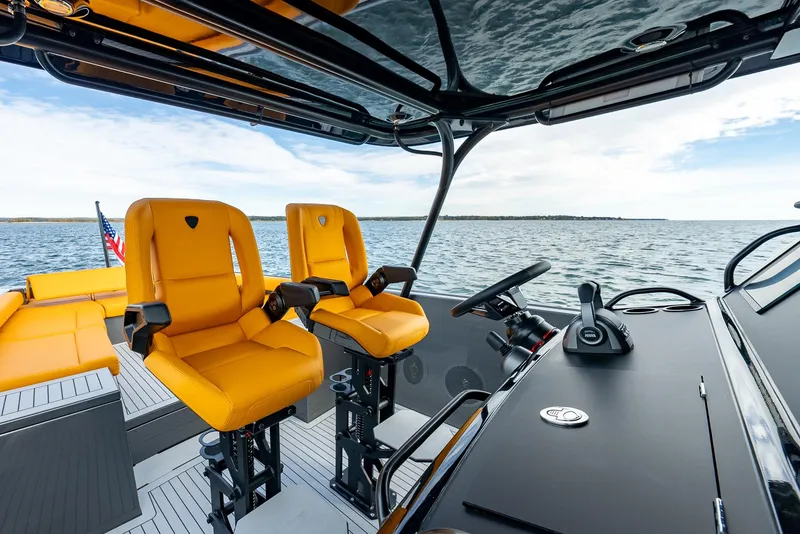 Slide: The Image of Luxury Wajer 38s boat interior with vibrant orange seats, 2025 model, on open water. - 15