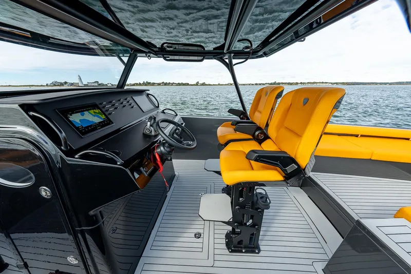 Slide: The Image of 2025 Wajer 38s boat interior with yellow seats and modern dashboard on water. - 17