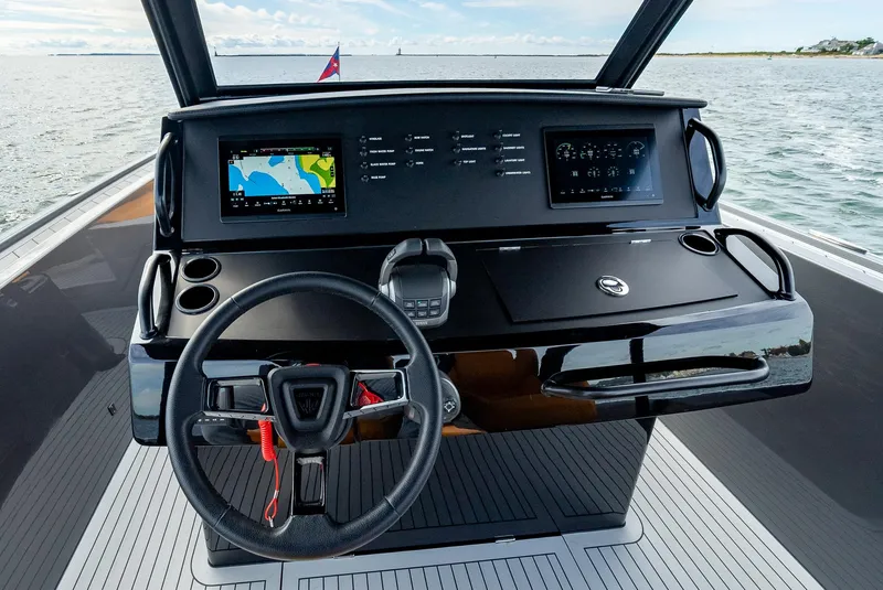 Slide: The Image of 2025 Wajer 38s yacht dashboard with modern navigation screens and steering wheel. - 21