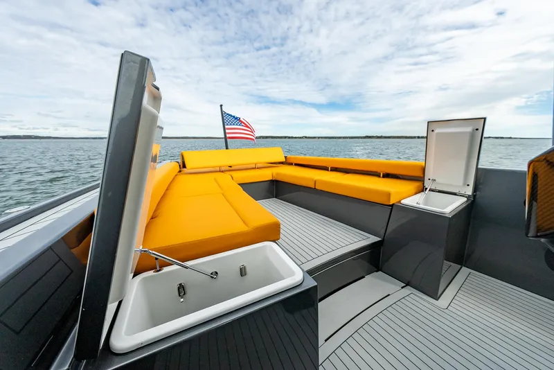 Slide: The Image of Luxurious 2025 Wajer 38s yacht with vibrant orange seating and American flag. - 22
