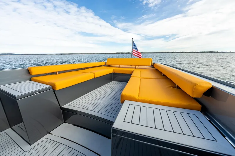 Slide: The Image of Luxurious 2025 Wajer 38s yacht with orange seating, American flag, and scenic ocean view. - 23