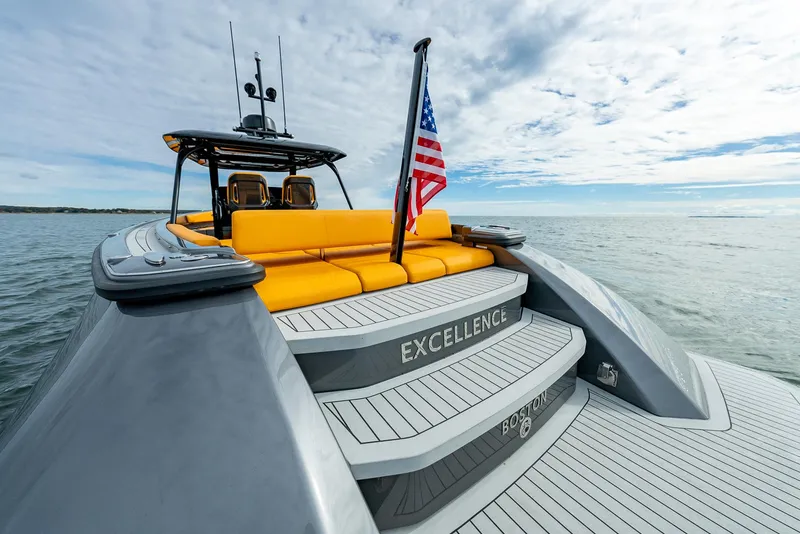 Slide: The Image of Wajer 38s 2025 luxury yacht with yellow seating and American flag on open water. - 27
