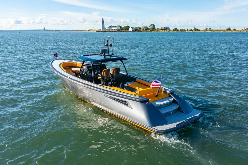 Slide: The Image of 2025 Wajer 38s luxury boat cruising on open water near a lighthouse. - 32