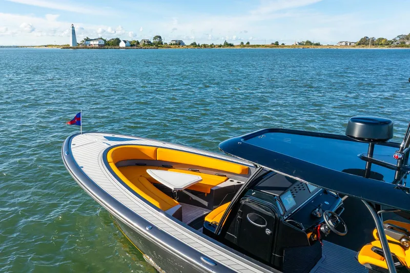 Slide: The Image of 2025 Wajer 38s luxury boat on serene water near a lighthouse. - 33