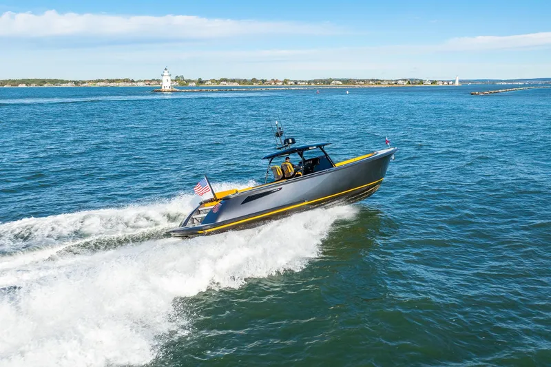 Slide: The Image of 2025 Wajer 38s yacht cruising on open water with lighthouse in background. - 37