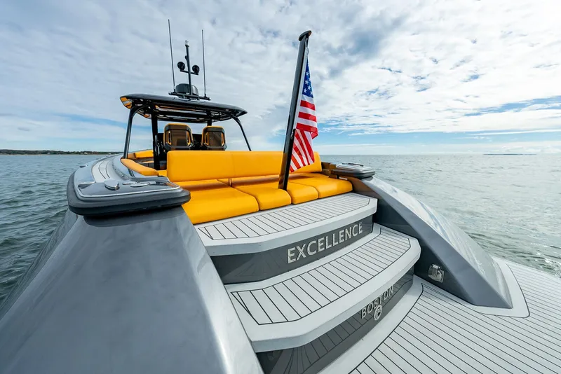 Slide: The Image of Wajer 38s 2025 yacht with yellow seating and American flag on open water. - 4