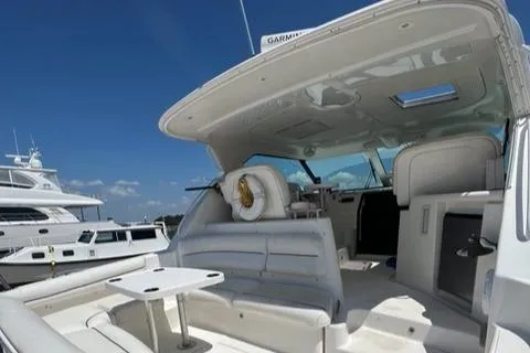 Slide: The Image of 2007 Tiara Yachts 4300 Sovran interior with seating and table under clear blue sky. - 10