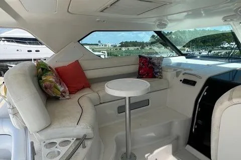 Slide: The Image of Interior of 2007 Tiara Yachts 4300 Sovran with plush seating and table. - 12