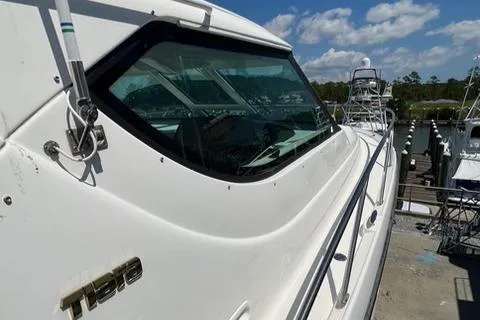 Slide: The Image of 2007 Tiara Yachts 4300 Sovran docked, showcasing sleek design and large windows. - 16